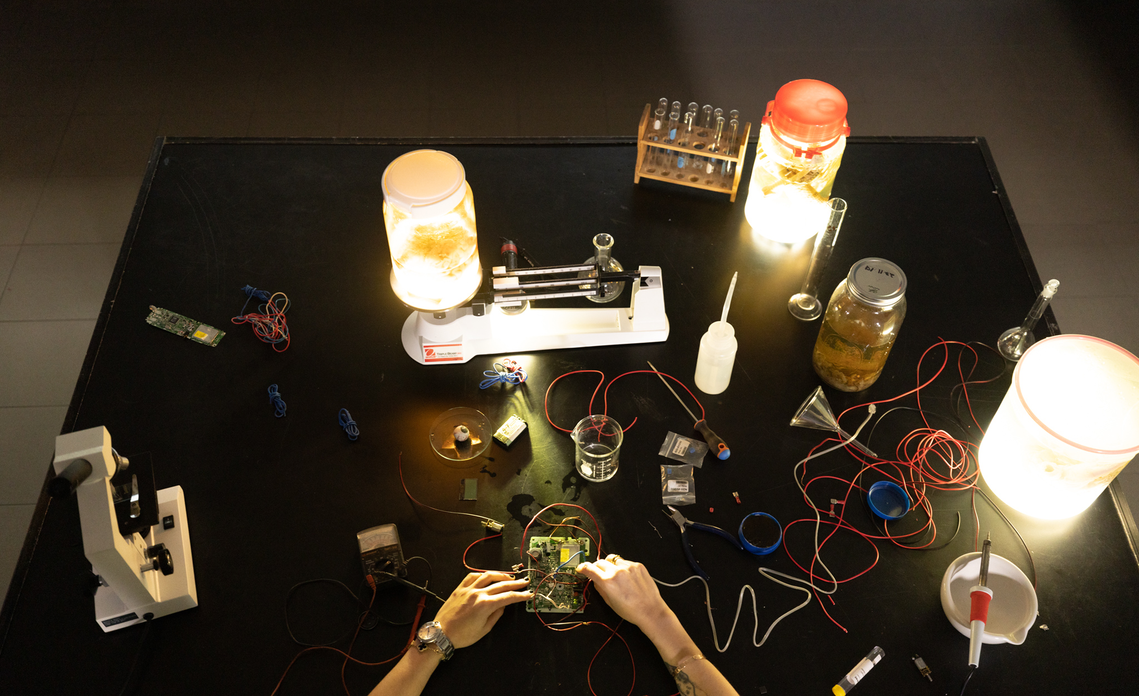 Cyborgism laboratory installation table with illuminated jars